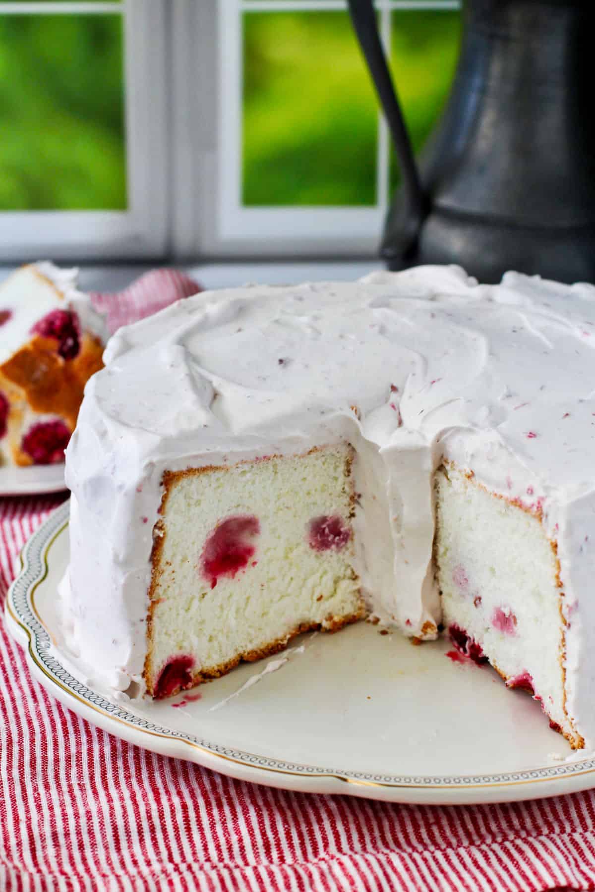 Angel Food Cake with Raspberry Whipped Cream with slices removed.