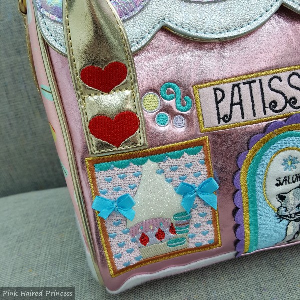 close up of heart embroidery on handle and window detail on bag