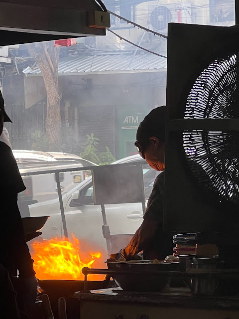 Jay Fai cooking in a flaming wok