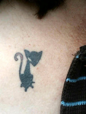 a leg tattoo of a severed horses head with flame horse shoe and crescent