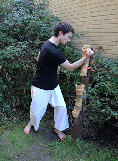 Practising inside-blocks (outside-forearm blocks) with the makiwara