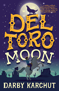 Book cover, 'Del Toro Moon' by Darby Karchut. Image depicts a boy atop a rearing stallion. A nighttime desert landscape is shown behind him. A howling wolf, silhouetted against the full moon, is perched atop the letter 'E' in the title-lettering