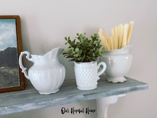 vintage ironstone pitcher filled with celluloid flatware