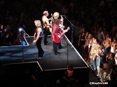 On the thrust...Def Leppard, Downstage Thrust Tour 2007, Joe Elliott, Vivian Campbell, Phil Collen, Rick Savage. Zoomed in from the nosebleed seats.My favorite band in the world. Zoomed in from the nosebleed seats. And yep, a smidge blurry.