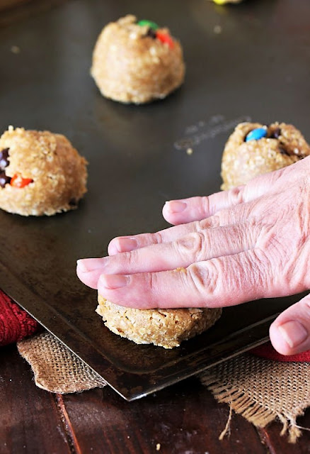 Pressing Down Monster Cookie Dough Ball with Hand Image