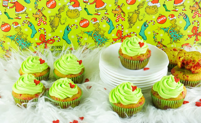 cupcakes displayed on white fur with green grinch background.