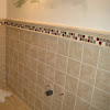 Ceramic Tile Bathroom Designs / How to Create the Bathroom Tile Design of Your Dreams ... / Cropped view of man holding container with pills near ceramic clean toilet bowl in modern restroom with grey tile.