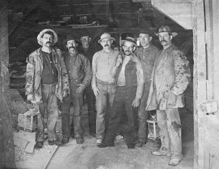 Comstock miners, two holding lanterns