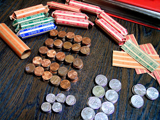 coins stacked and bank rolls