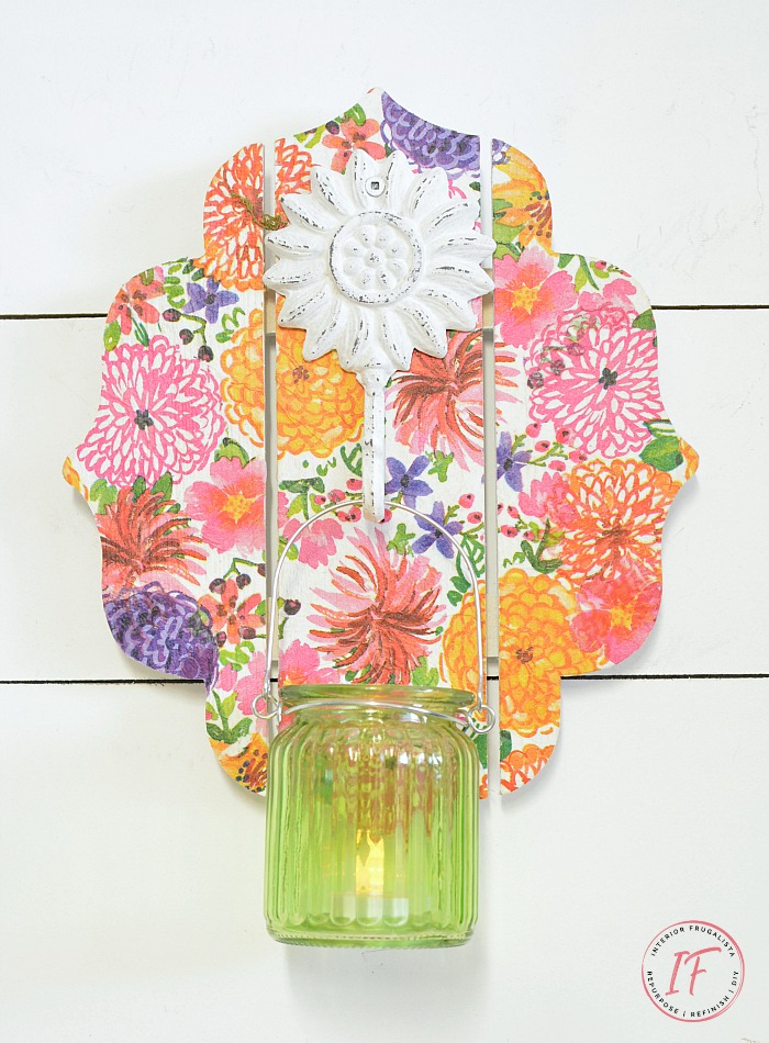 This DIY Decoupage Wall Sconce is an easy dollar store craft for Spring or Summer and can be used as a mason jar candle holder lantern or hanging flower vase.