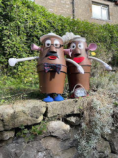 A Mr and Mrs Potato Head flower pot sculpture.