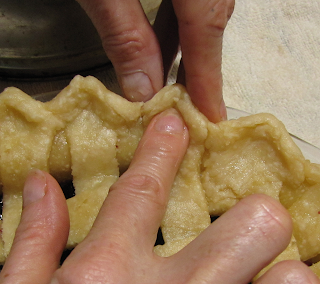 Three Fingers Demonstrating How to Crimp Crust Edge