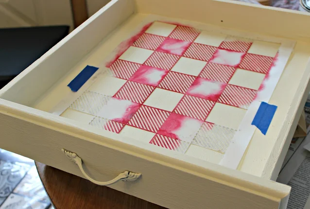 Photo of a drawer bottom getting a buffalo check stenciling