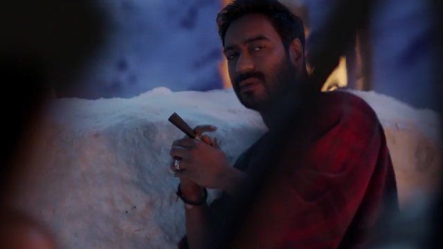 Ajay Devgn in and as Shivaay, Smoking a Cigar