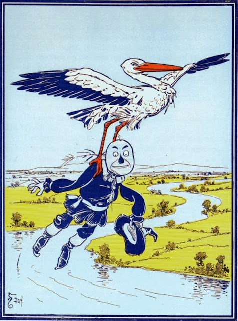 The Stork carrying the Scarecrow high above the river.