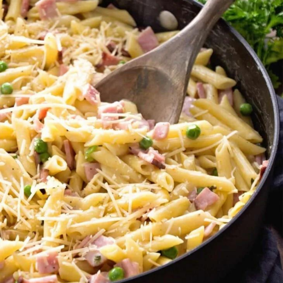 skillet containing pasta, veggies, ham and cheese