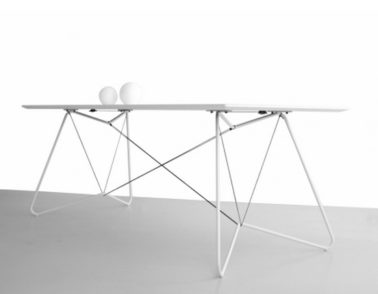 A combination of gray tubes and strings hold white laminated dining room table together