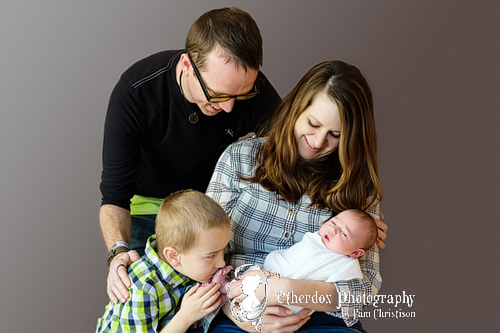 Professional portrait of a newborn baby and her family