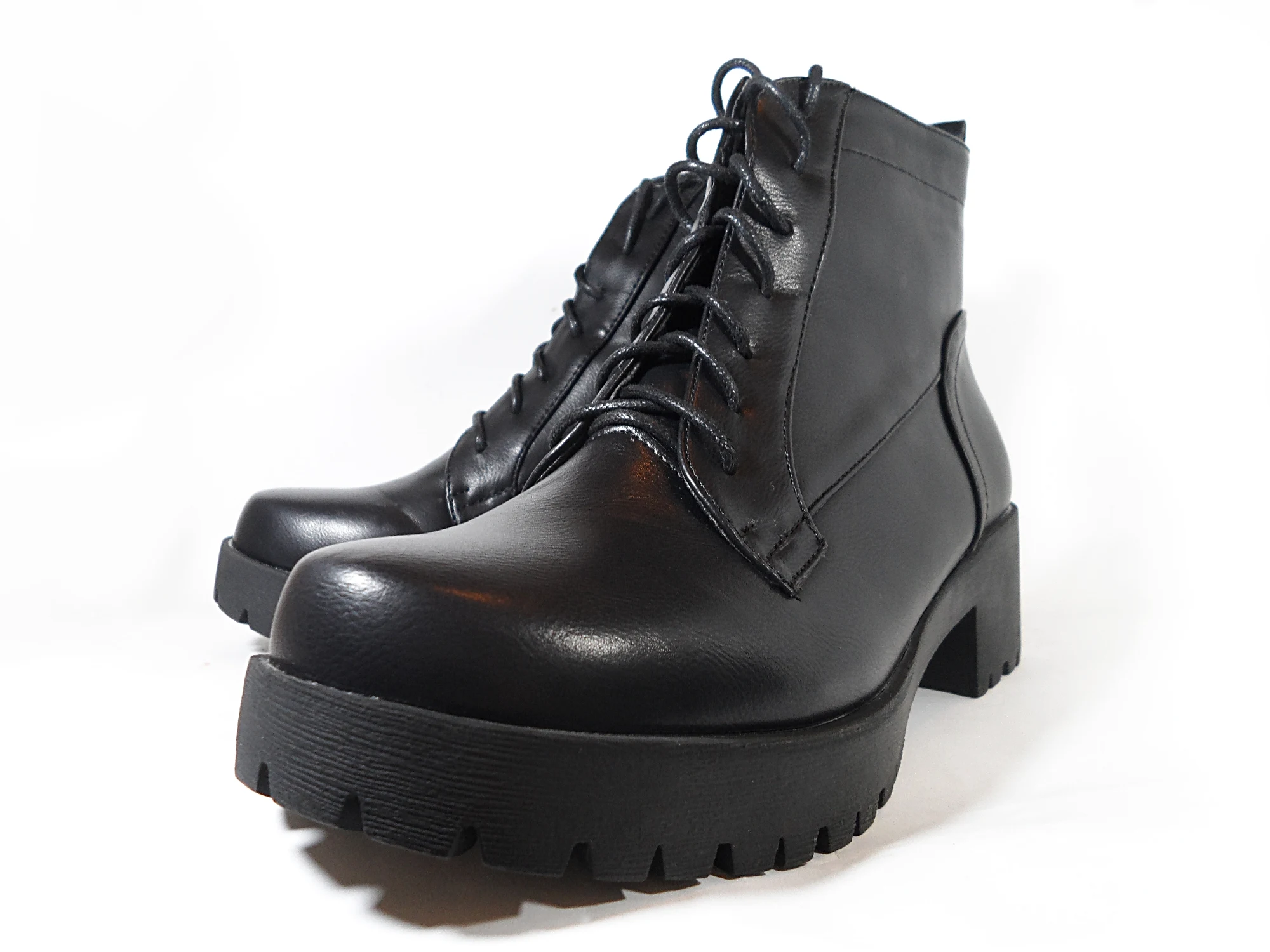 close-up of a black combat boots on a white background in the studio