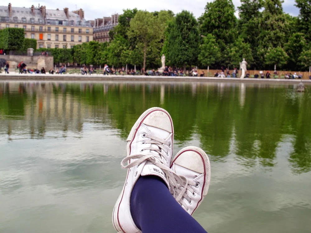 white leather Converse Chuck Taylor trainers in the Jardins des Tuileries, Paris