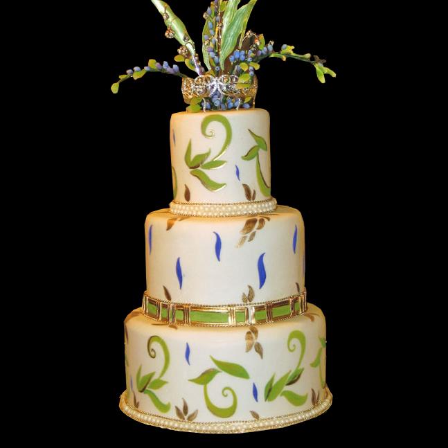 Gold purple and green hand painted wedding cake a row of pearls lines each 