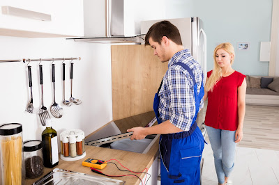 A induction hob being fitted in a kitchen.