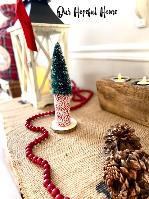 Christmas vignette sideboard lantern red wood bead garland