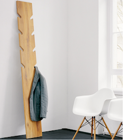 coat rack, wood, leans against wall