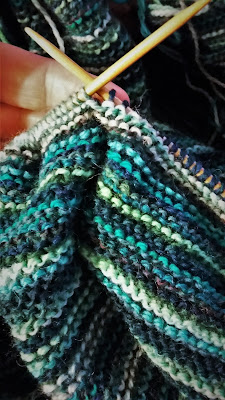 Just one more row of knitting before I bind off shawl or blanket scarf