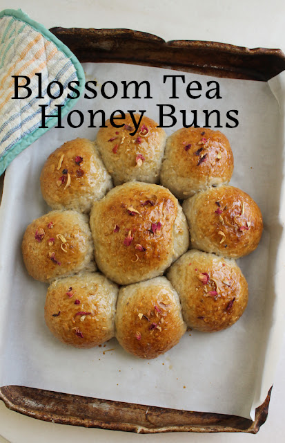 Food Lust People Love: Made with a fragrant tea mix of hibiscus, rose and orange blossoms, paired with ginger and apple, these blossom tea honey buns have a subtle floral note that goes excellently with a hot cup of tea.  For these blossom tea honey buns, I used a Tiesta tea  that my grocery store called Ginger Sweet Peach, despite the complete lack of peaches in the mix. You can use your favorite fruit infusion to make these buns.