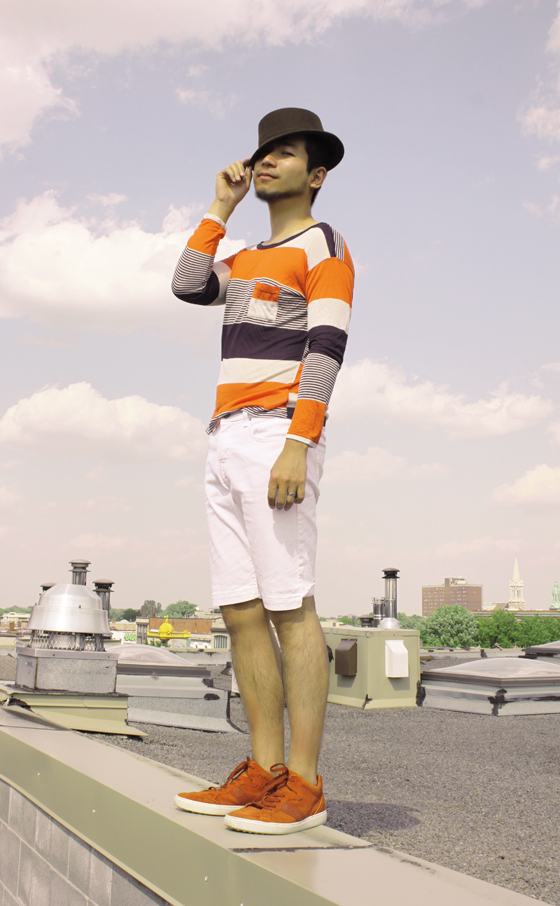 Summer look of man in Montreal, style of fashion illusrator Ben Liu, inspired by movie Death in Venice, stripe long sleeve vintage t-shirt, brown bowler hat, white shorts jeans by Levis, orange Tod's swede Sneakers