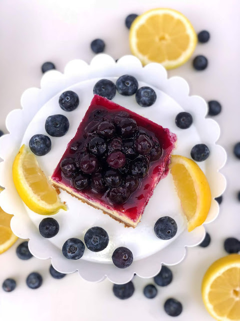 Lemon blueberry cheesecake bars recipes. Lemon cheesecake with blueberry topping and graham cracker crust.