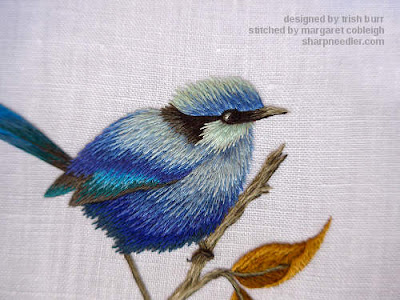 Close-up of thread painted blue bird showing added shadows and details