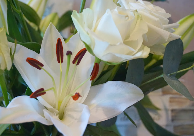 close up photo of an oriental lily and avalanche rose