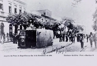 Bonde virado na praça da República em protesto contra a lei da vacinação obrigatória da varíola. Cartão-postal. Rio de Janeiro, 14 nov. 1904