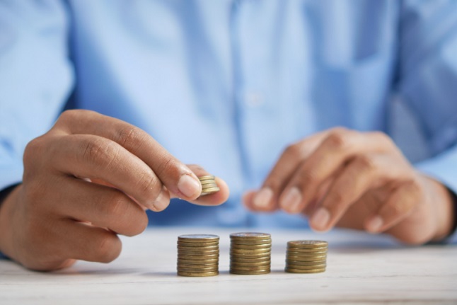 A man is seen dividing his income for easier budgeting