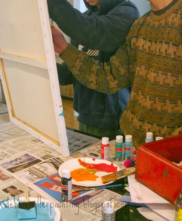 teenagers collaborating on a painting