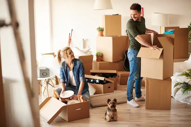 A family packing boxes to move