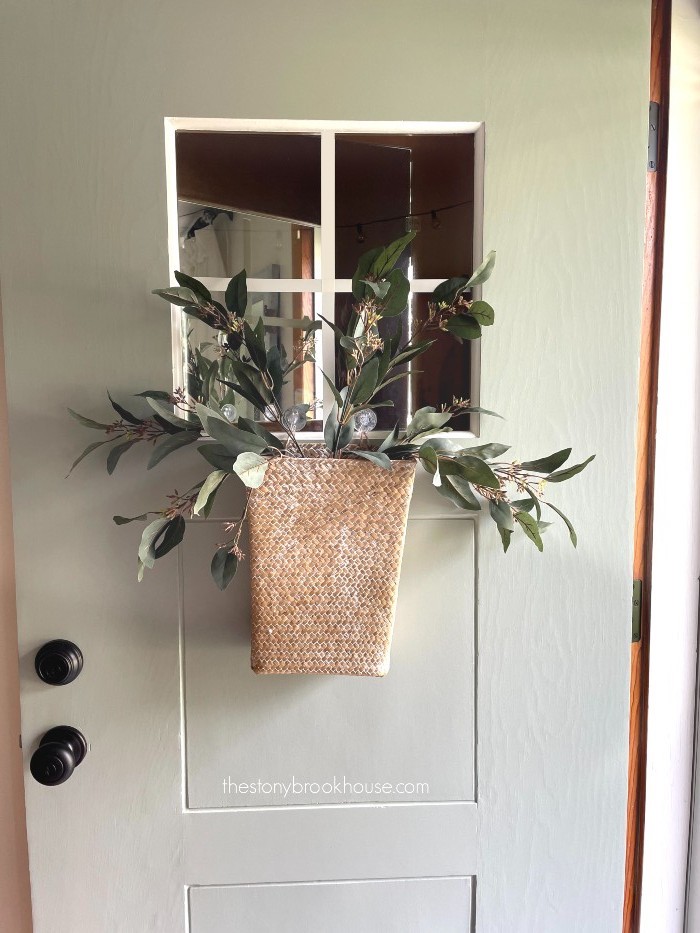 Adding greenery to front door basket