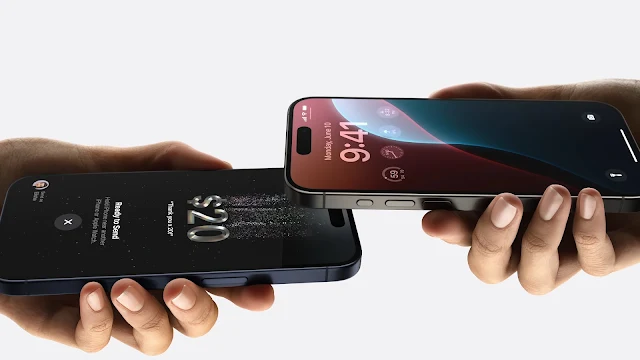 Two iPhones held close together, likely using the Tap to Cash feature to send or receive money. The iPhone screen on the left displays “$20.00 Ready to Send” and “Matt,” while the iPhone screen on the right displays a notification that says “$20.00.”