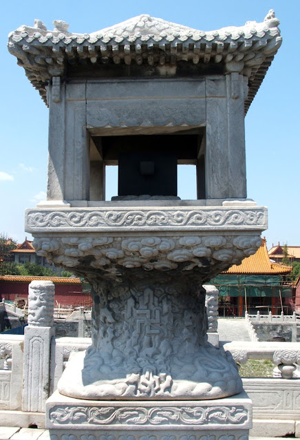 Stone grain measure box with swastika on the base.