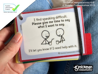 White hand holding a laminated card with pale blue border and 2 stickmen chatting over coffee. Text "I find speaking difficult. Please give me time to say what I want to say. I'll let you know if I need help with it."