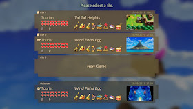 The save file menu of the game with two completed save games that have a star on it. The first is named Tourian, the second is named Tourist and has the Hero Mode icon on it.