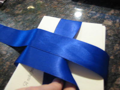 How To Tie A Bow With Ribbon. Step Five: Pull the ribbon you