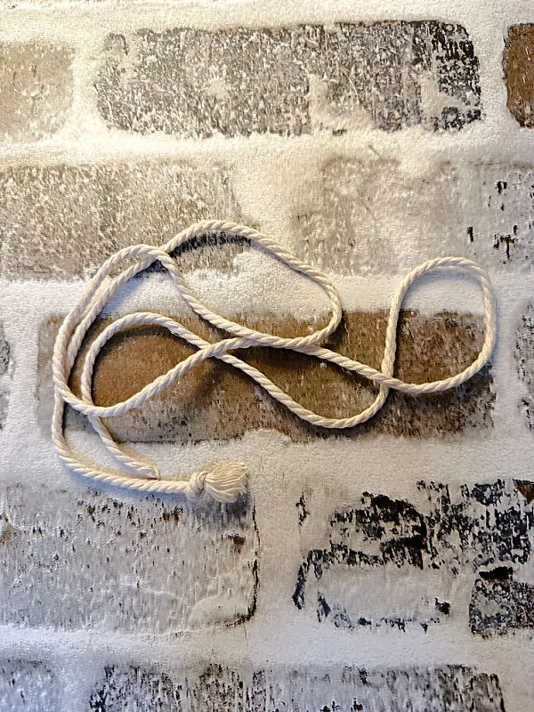 brick background with white string