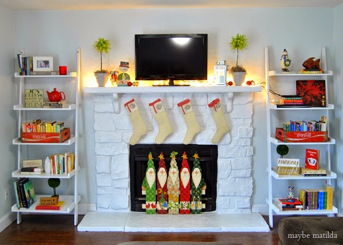 Stone fireplace painted white, dressed up for Christmas.