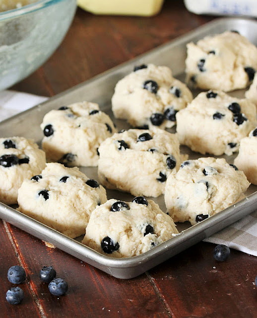 Shaped Blueberry Biscuit Dough Mounds on Baking Sheet Image