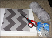 I gathered a square canvas, grey yarn, glue sticks and a chevron stencil I . (chevron)