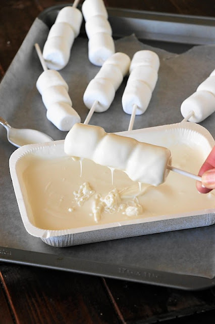  can whip out a batch of these super easy and fun  Christmas White Chocolate Marshmallow Pops