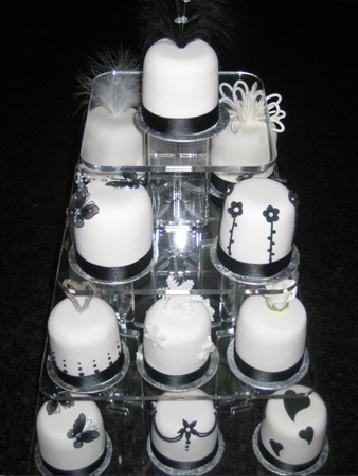 Black and white mini cakes with flowers butterflies and hearts